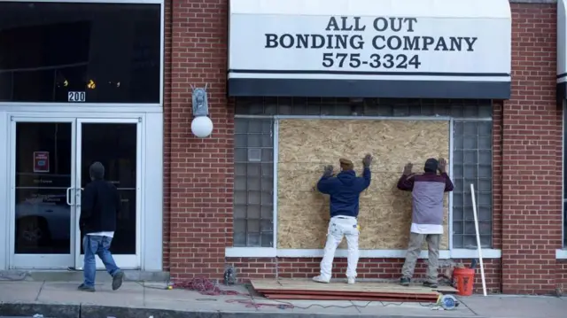 People boarding up windows