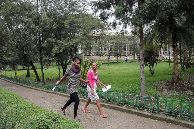 Two women walk on a university campus in Ethiopia.