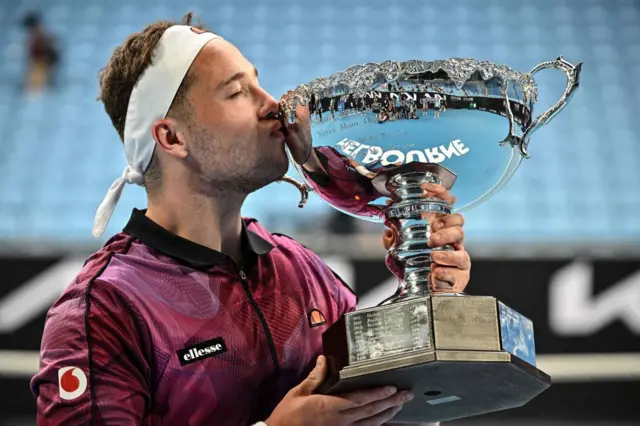 Alfie Hewett kisses the Australian Open title