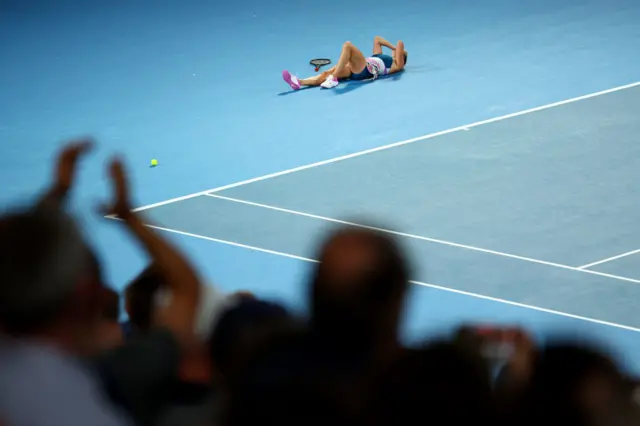 Sabalenka lies on the court after winning