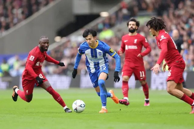 Kaoru Mitoma of Brighton & Hove Albion is surrounded by Liverpool players