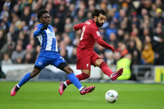 Mohamed Salah takes a shot against Brighton