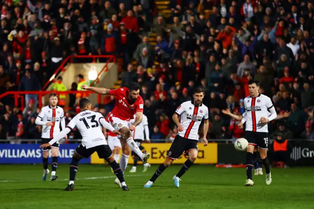 Ollie Palmer of Wrexham shoots against the crossbar