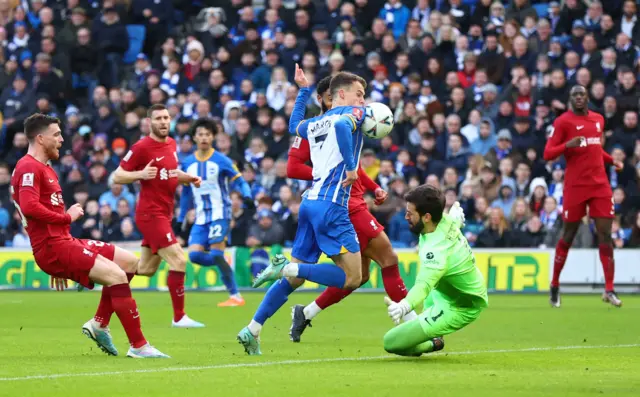 Alisson saves Solly March's shot