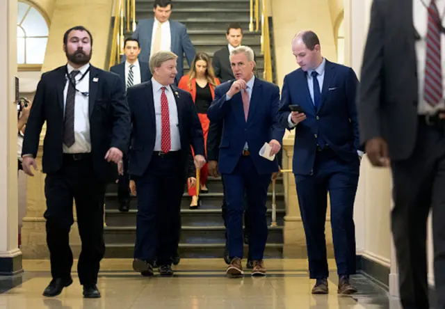 Kevin McCarthy walks to a meeting with House Republicans