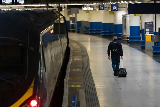 Man walking beside stationary train