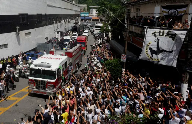 Pele's coffin being carried on a fire engine