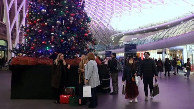 Passengers on the concourse at King's Cross station in London