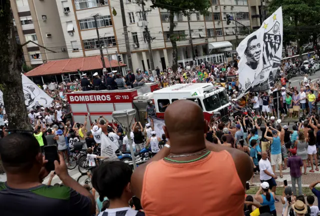 Fans in Santos watch Pele's coffin being carried through the city on a fire truck