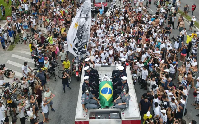 Pele's coffin on a fire truck being carried through Santos