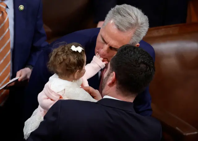 Republican Kevin McCarthy entertains the daughter of fellow lawmaker Mike Lawler during a break in proceedings. McCarthy failed to win the House leadership in three rounds of voting