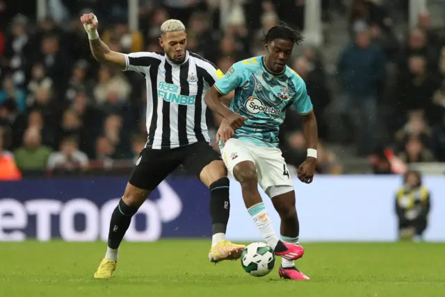 Newcastle United's Joelinton in action with Southampton's Romeo Lavia