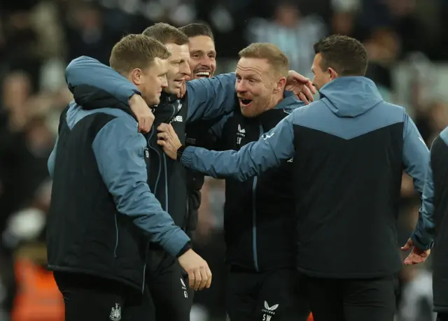 Eddie Howe celebrates with his coaching staff