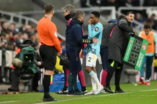 Kyle Walker-Peters leaves the field with an injury