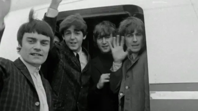 The Beatles entering a plane