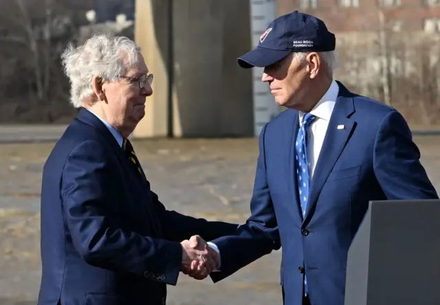 Biden is visiting Kentucky with top Senate Republican Mitch McConnell (left)