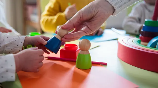 Children playing with colourful wooden toys