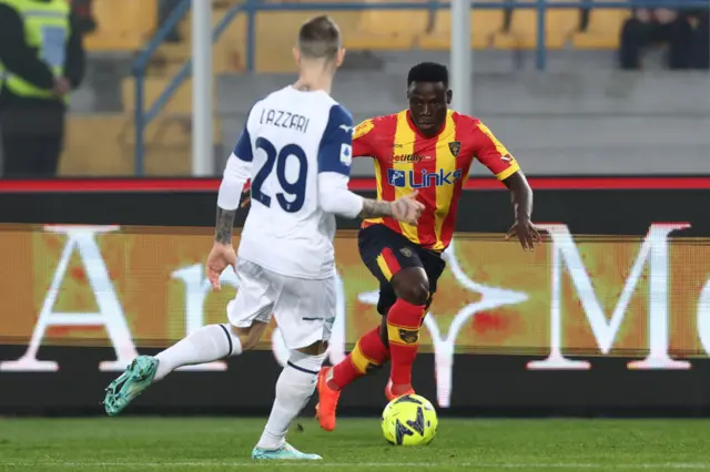 Lameck Banda of Lecce competes for the ball with Manuel Lazzari of Lazio during the Serie A match