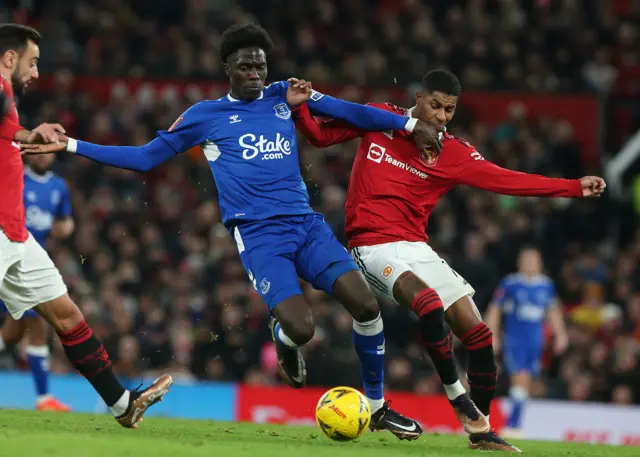 Marcus Rashford of Manchester United in action with Amadou Onana of Everton during the Emirates FA Cup Third Round match between Manchester United and Everton at Old Trafford