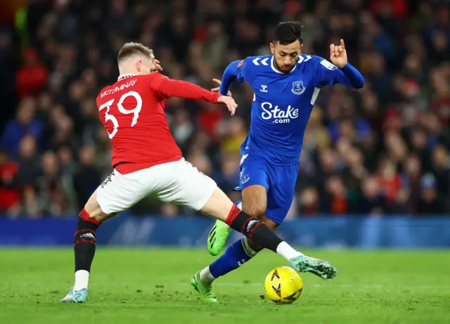 Everton's Dwight McNeil in action with Manchester United's Scott McTominay