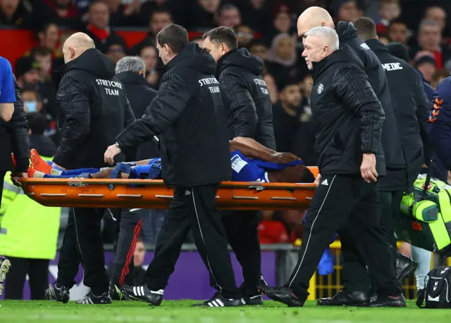 Alex Iwobi is taken off on a stretcher