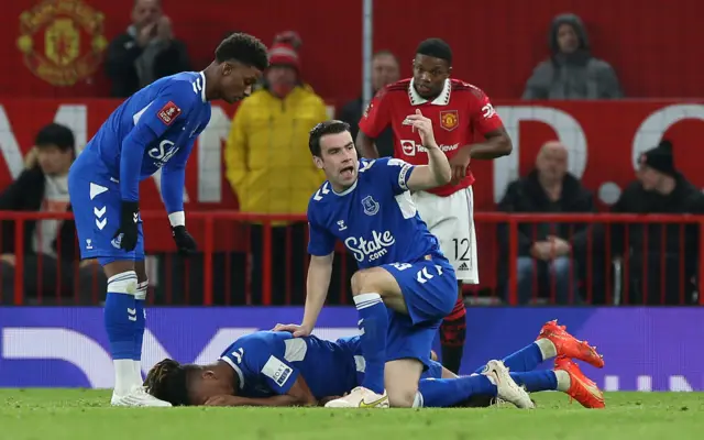 Alex Iwobi of Everton lies injured during the Emirates FA Cup Third Round match between Manchester United and Everton at Old Trafford