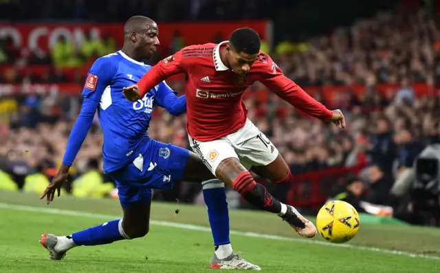 Everton's Abdoulaye Doucoure (L) in action against Manchester United's Marcus Rashford (R) during the FA Cup third round match between Manchester United and Everton in Manchester