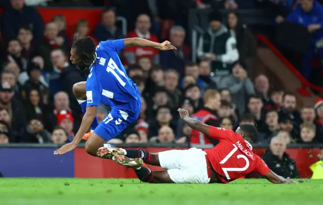 Everton's Alex Iwobi in action with Manchester United's Tyrell Malacia