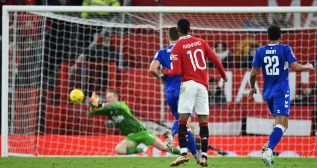 Jordan Pickford saves a Marcus Rashford effort