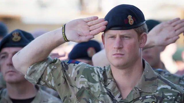 Prince Harry makes a military salute while in uniform