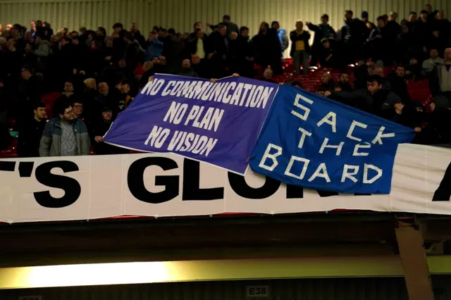 Everton fans hold up banners saying "no communication, no plan, no vision" and "sack the board" after their 3-1 defeat at Manchester United in the FA Cup third round