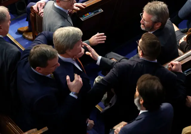 Rep Mike Rogers is restrained while shouting at colleague Matt Gaetz