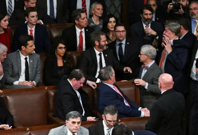 Rep Mike Rogers is restrained while shouting