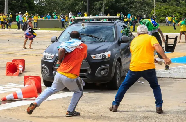 Protesters have been seen attacking police cars