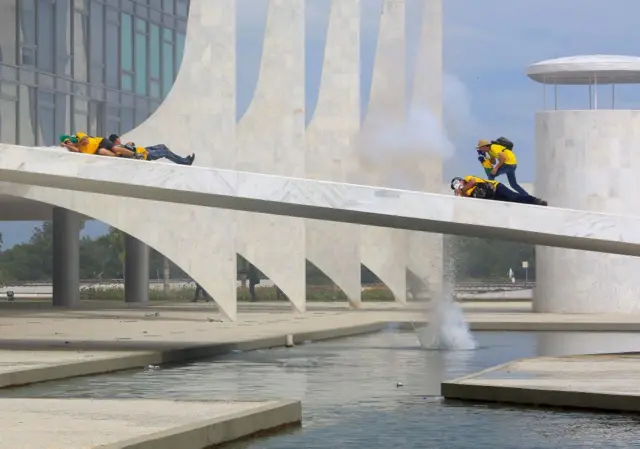 Protesters on a building structure