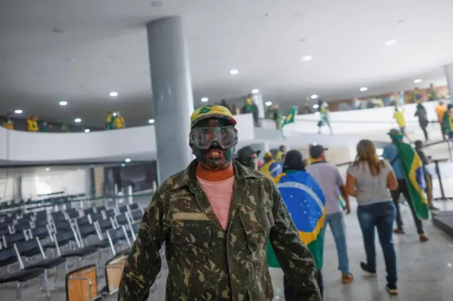 A supporter of Brazil's former President Jair Bolsonaro is pictured inside the Planalto Palace