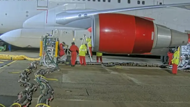 Technicians working on Virgin Orbit plane