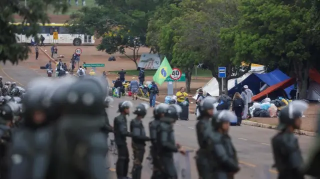 Brazilian security forces observe the clearance of protests camps in Brasília