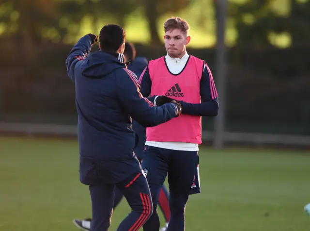 Arsenal's Emile Smith Rowe gets instructions from Gunners boss Mikel Arteta during a training session