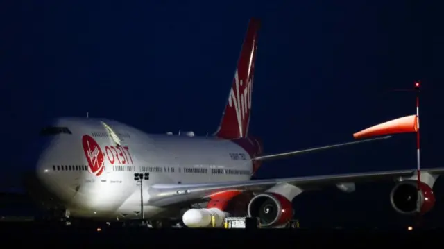 Cosmic Girl, a Virgin Boeing 747-400 aircraft sits on the tarmac with Virgin Orbit's LauncherOne rocket attached to the wing, ahead of the first UK launch tonight, at Spaceport Cornwall at Newquay Airport in Newquay, Britain, January 9, 2023.