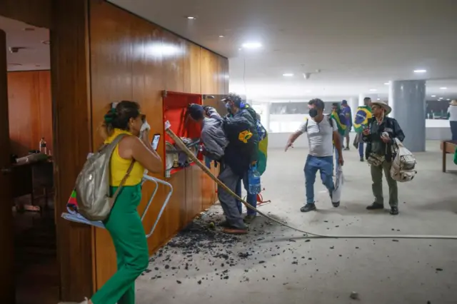 Supporters of Brazil's former President Jair Bolsonaro damage the interior of Planalto Palace