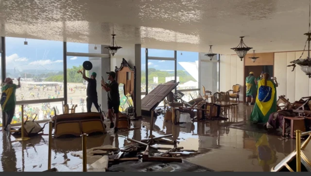 Shattered furniture and smashed windows is scene in the government building