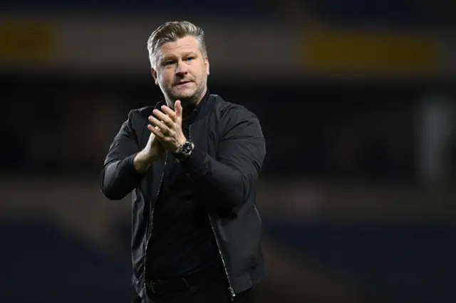 Oxford United manager Karl Robinson claps the fans