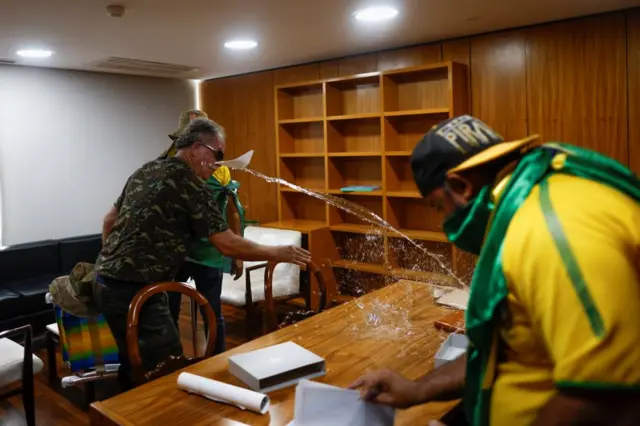 Supporters of Brazil's former President Jair Bolsonaro damage the interior of Planalto Palace