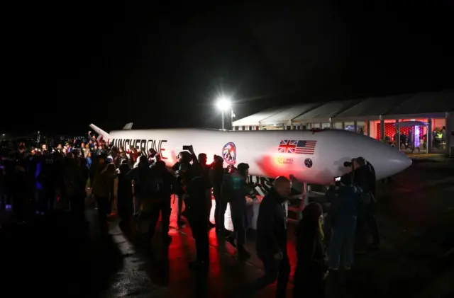 Spectators gather around a replica rocket at Cornwall Airport Newquay to watch the first ever UK launch of Virgin Orbit's LauncherOne rocket from Spaceport Cornwall in Newquay, Britain, January 9, 2023.