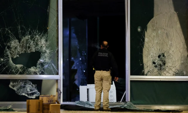 A police offer inspects the damage at the Supreme Court