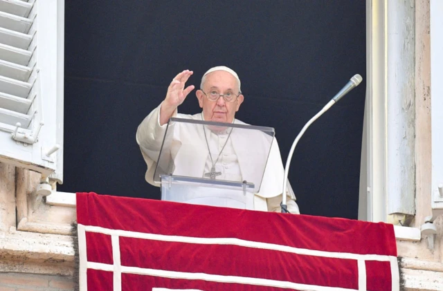 Pope Francis waves from the balcony in St Peter's Square, Vatican City