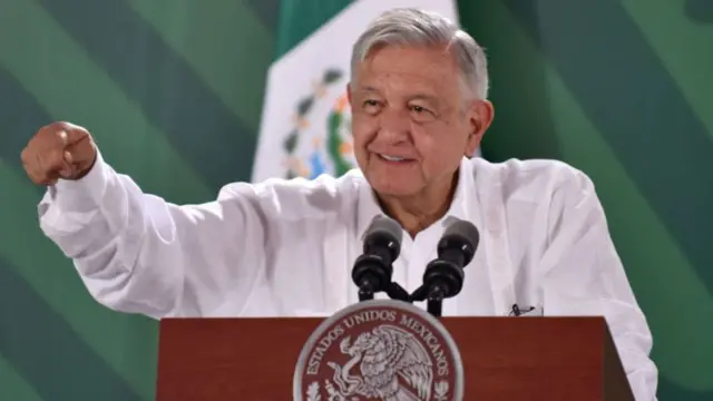 Mexican President Andres Manuel Lopez Obrador behind a microphone