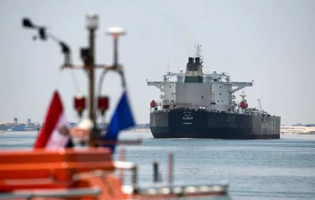 Ships sail through the Suez Canal in the north-eastern Egyptian city of Ismailiya, on May 27, 2021