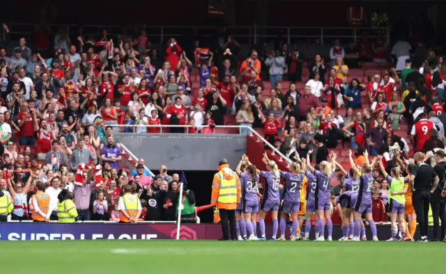 Liverpool celebrate their famous win in front of the travelling fans.